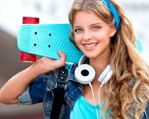 Adolescente sonriendo con tratamiento de ortodoncia juvenil